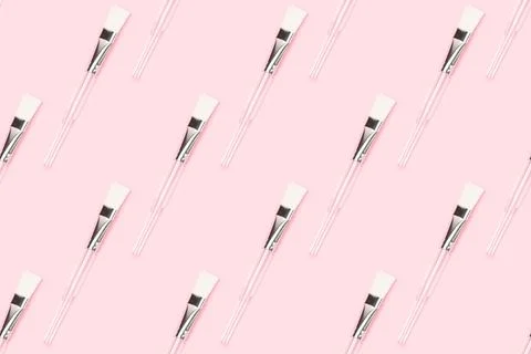 Repetitive pattern made of makeup brush with transparent handle. Stock Photos