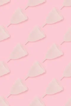 Repetitive pattern made of menstrual cup on a pink background. Stock Photos