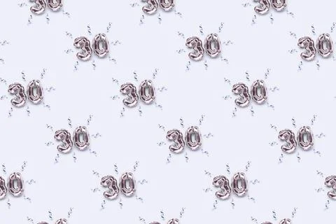 Repetitive pattern made of number 30 silver air balloons. Stock Photos