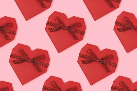 Repetitive pattern made of red gift box in a heart shape. Stock Photos