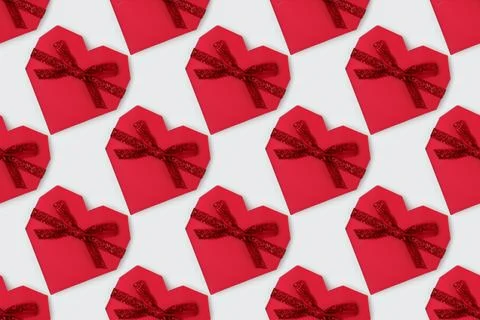 Repetitive pattern made of red gift box in a heart shape. Stock Photos