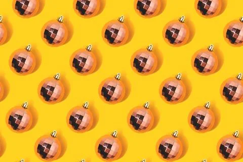 Repetitive pattern made from rose gold colored Christmas baubles. Stock Photos