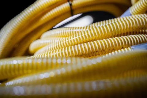 Repetitive pattern of yellow coiled pipes Stock Photos