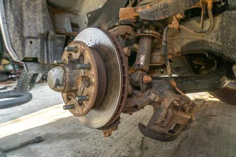 Replace brake disc and pads Front Disk brake assembly on an old car - Brake j Stock Photos