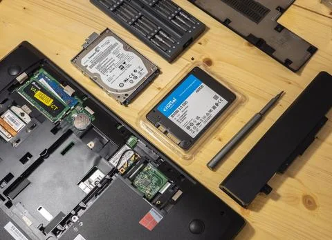 Replace hard disk on solid state drive for computer notebook on wood background Stock Photos