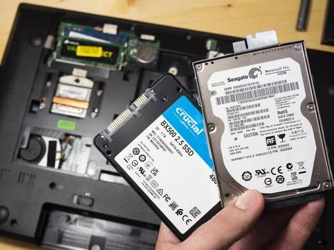 Replace hard disk on solid state drive for computer notebook on wood background Stock Photos
