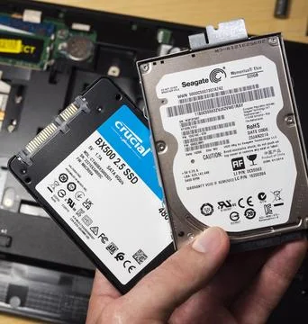 Replace hard disk on solid state drive for computer notebook on wood background Stock Photos