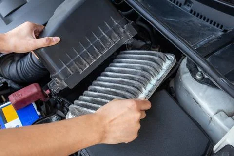 Replace old and dirty car air filters by hand. 写真素材