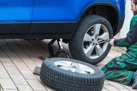 Replace summer tires against winter tires Stock Photos