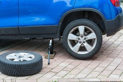 Replace summer tires against winter tires Exchanging the car tires. From s... Stock Photos
