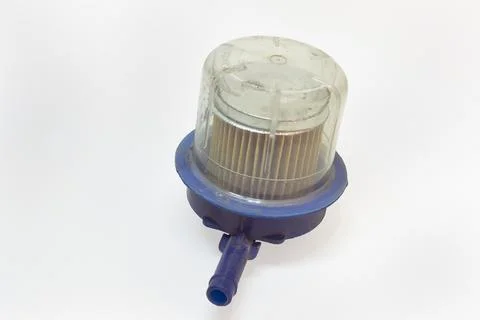 Replaceable fuel filter with transparent sump, in plastic housing, old, dis.. Stock Photos