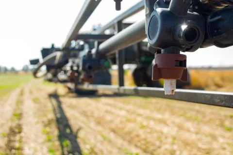 Replaceable sprayer of a field high-clearance sprayer on a hinged boom Stock Photos