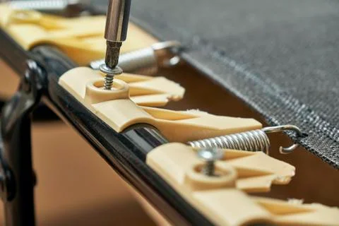 Replacement of broken plastic bed slat holders on folding bed 写真素材