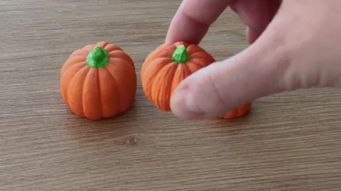 Replacement of the Halloween pumpkin statue among the other two on the table, 4K Stock Footage 253574180