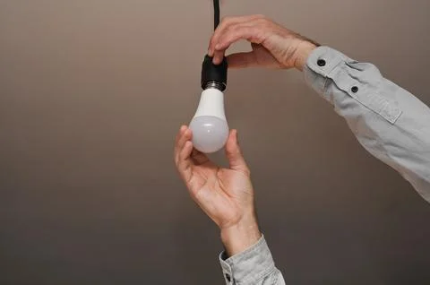 Replacement of the LED lamp. energy efficiency. Stock Photos