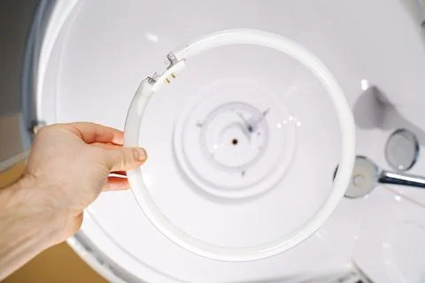 Replacement of an old fluorescent lamp with a ring LED module. Stock Photos