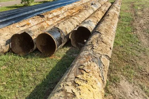 Replacement of old rusted broken metal water pipes with modern plastic pipes. Stock Photos