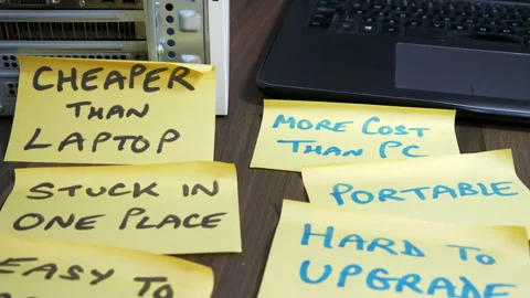 Replacement PC vs laptop - pros and cons notes on desk. Stock-Footage 143840035