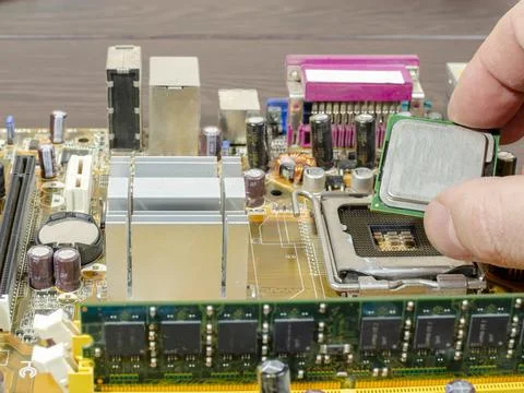 Replacement of the processor on the motherboard close-up Stock Photos