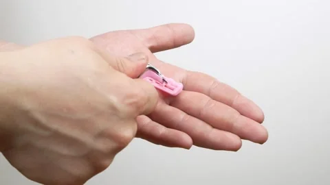Replacement of the razor on the machine.The blade lies on the hand. Stock Footage 134612089