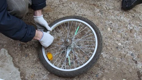 Replacement of rubber on the Bicycle wheel. Stock Footage 108452870