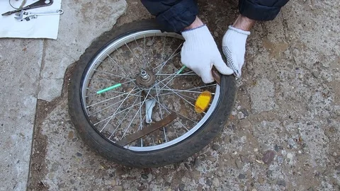 Replacement of rubber on the Bicycle wheel. Stock Footage 108452871