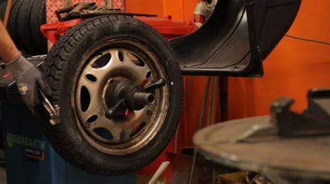 Replacement of a wheel in a garage Stock Footage 61013553