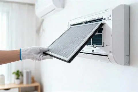 Replacing an air conditioner filter for improved air quality and efficiency Stock Photos