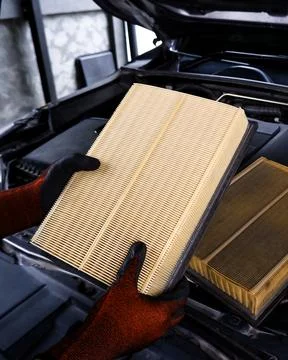 Replacing air filter in automotive engine Stock Photos