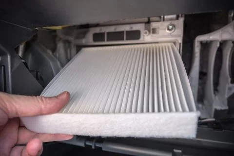 Replacing the air filter in the car. Stock Photos