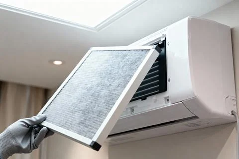Replacing the air filter in a modern wall-mounted air conditioning unit Stock Photos