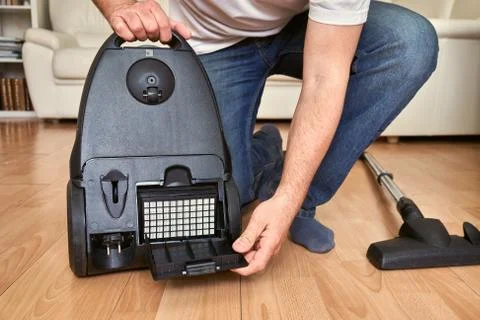 Replacing an air filter in vacuum cleaner at home. 写真素材