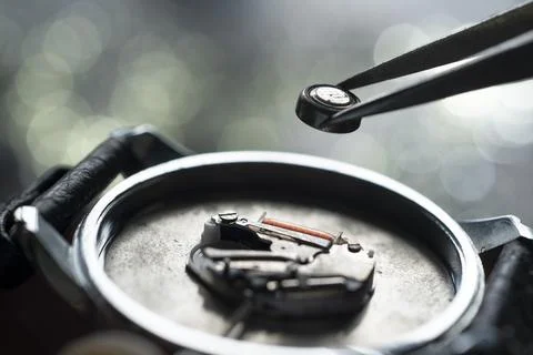 Replacing the battery in the electronic clock Stock Photos