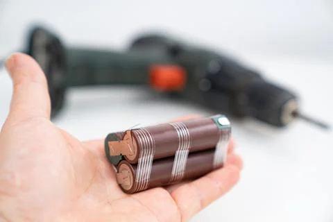 Replacing battery pack in screwdriver with new ones. battery assembly In hand Stock Photos