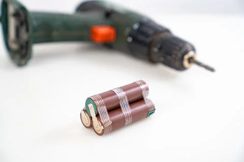 Replacing battery pack in screwdriver with new ones. Focus on battery assembly Stock Photos