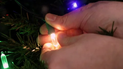 Replacing broken Christmas light Stock Footage 323246466
