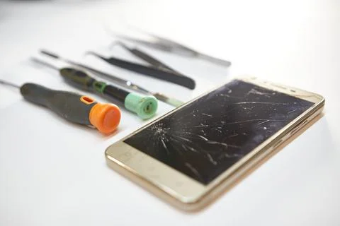 Replacing a broken screen. Mobile phone repair. Mobile device service. Stock Photos
