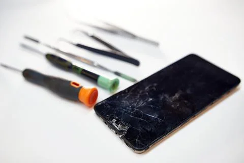 Replacing a broken screen. Mobile phone repair. Mobile device service. Stock Photos