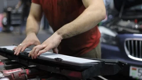 Replacing the cabin filter in a car at a car service center Stock Footage 252013940