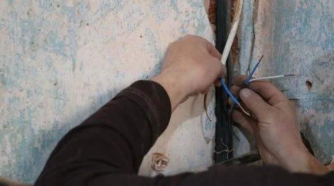 Replacing a cable in a groove in a concrete wall Stock Photos