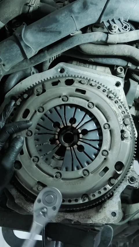 Replacing car clutch system and pressure plate in automotive workshop Stock Footage 332858563