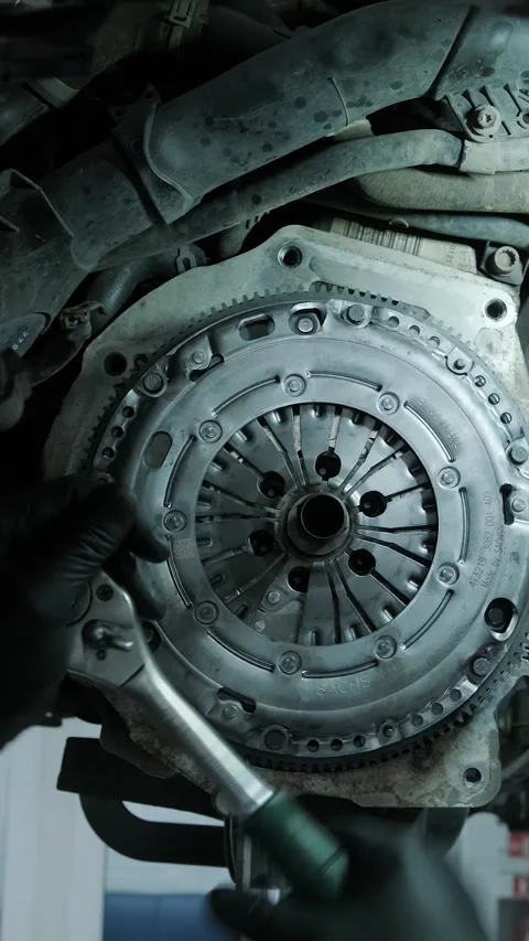Replacing car clutch system and pressure plate in automotive workshop Stock Footage 332858602