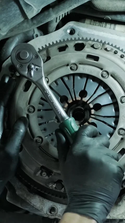 Replacing car clutch system and pressure plate in automotive workshop Stock Footage 332858618