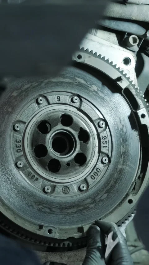 Replacing car clutch system and pressure plate in automotive workshop Stock Footage 332858628