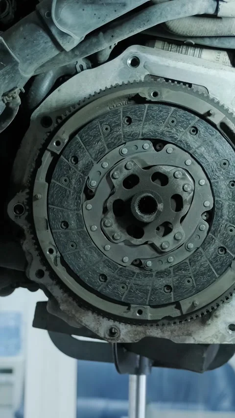 Replacing car clutch system and pressure plate in automotive workshop Stock Footage 332858642