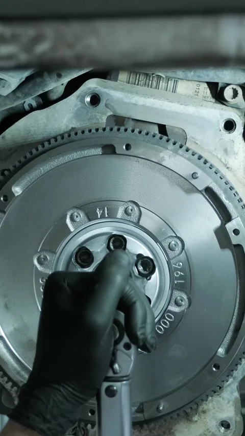 Replacing car clutch system and pressure plate in automotive workshop Stock Footage 332858643