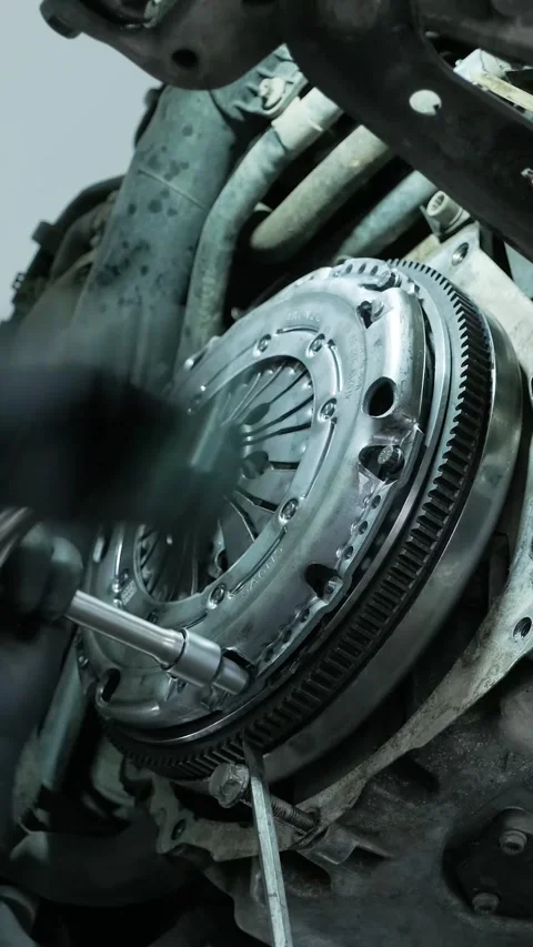 Replacing car clutch system and pressure plate in automotive workshop Stock Footage 332858651