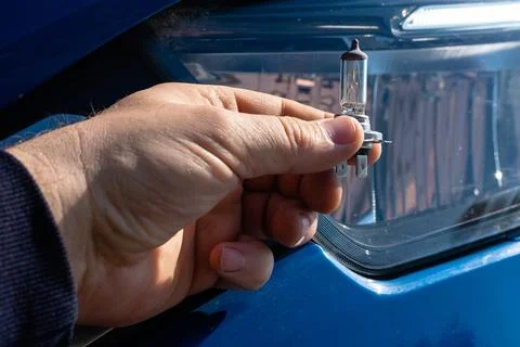 Replacing car headlight bulb close up maintenance Stock Photos