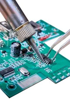 Replacing a damaged part in an electronic circuit board using a soldering iro Stock Photos