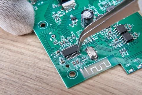 Replacing a damaged part in an electronic circuit board using a soldering iro Stock Photos